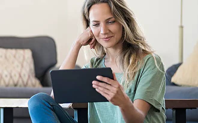 A Woman looking at her tab